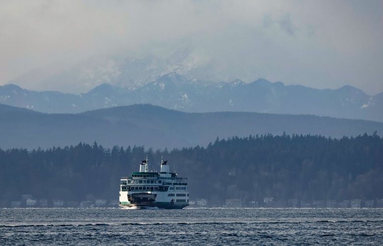 With fresh dusting of snow on the Olympic Mountains the M/V Suquamish makes her way to Bainbridge Island Saturday Dec. 2, 2023 in Seattle.  225645