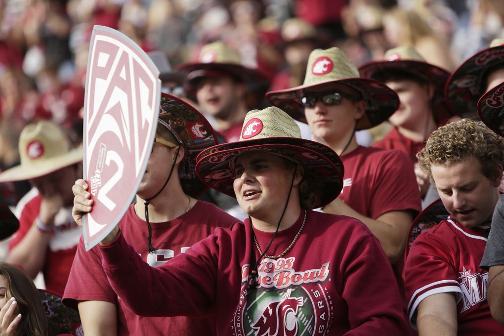 Washington State University student Michael Smith holds a “Pac-2” sign during warmups before an NCAA college football game between Washington State and Oregon State, Saturday, Sept. 23, 2023, in Pullman, Wash.... (Young Kwak / The Associated Press)