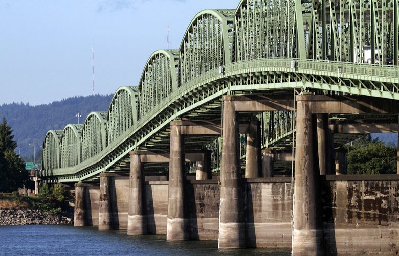 FILE – In this, Aug. 4, 2011, file photo, taken in Vancouver, Wash., the Interstate 5 bridge spans the Columbia River between Oregon and Washington. (AP Photo/Don Ryan) ORDR205