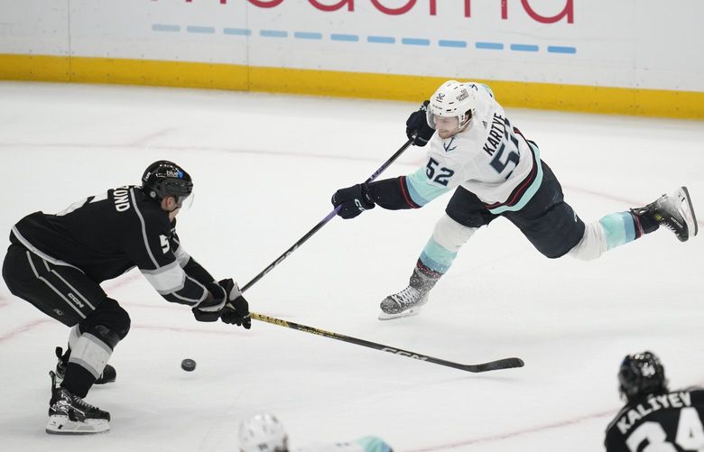 Seattle Kraken’s Tye Kartye shoots against Los Angeles Kings defenseman Andreas Englund (5) during the second period of an NHL hockey game Wednesday, Dec. 20, 2023, in Los Angeles. (AP Photo/Ashley Landis) LAS214 LAS214