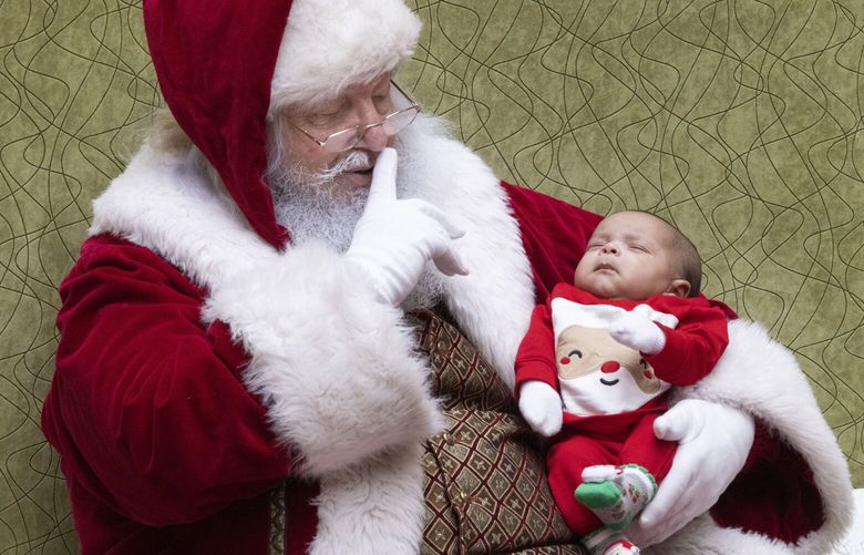 One-and-a-half month old D. J. Dixon seems to be napping during his very first visit to Santa at the Tacoma Mall Wednesday, December 20, 2023.  Santa will be there and is available for photos or just a visit from 10 a.m. to 8 p.m. from Thursday through Saturday and from 11 a.m. to 6 p.m. on Sunday, Christmas Eve. 225812