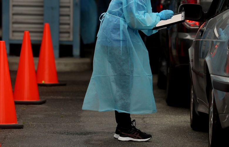 Registration technicians work at the City of Seattle’s Community Testing Site CQ on Aurora Avenue N. 214509