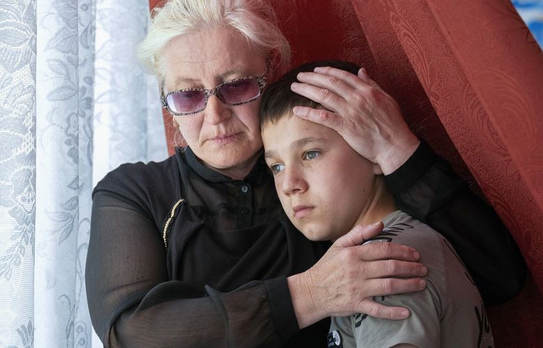 Oklesandr Radchuk, 13, with his grandmother, Lyudmyla Siryk near Chernihiv, Ukraine, May, 29, 2023. Thousands of young Ukrainians were separated from their parents by the Russian authorities in the early stages of the war. They are among the most forlorn victims of the invasion. (Daniel Berehulak/The New York Times) — FOR EDITORIAL USE ONLY WITH NYT STORY UKRAINE STOLEN CHILDREN BY CARLOTTA GALL FOR DEC. 28, 2023. ALL OTHER USE PROHIBITED. — XNYT0616 XNYT0616