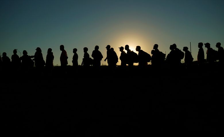 FILE – Migrants who crossed the Rio Grande and entered the U.S. from Mexico are lined up for processing by U.S. Customs and Border Protection, Sept. 23, 2023, in Eagle Pass, Texas. Texas began flying migrants from the U.S.-Mexico border to Chicago on Wednesday, Dec. 20, a week after the city took a tougher stance on the buses that Republican Gov. Greg Abbott has been sending north since last year. (AP Photo/Eric Gay, File)