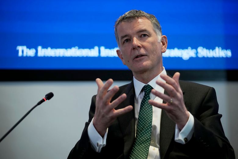 FILE – Richard Moore, the Chief of Britain’s Secret Intelligence Service, also known as MI6, answers questions at the International Institute for Strategic Studies, in London, on Nov. 30, 2021. The head of Britain’s foreign intelligence agency has thanked Russian state television for encouraging Russians to spy for the UK after it broadcast part of a speech he gave earlier this year. (AP Photo/Matt Dunham)