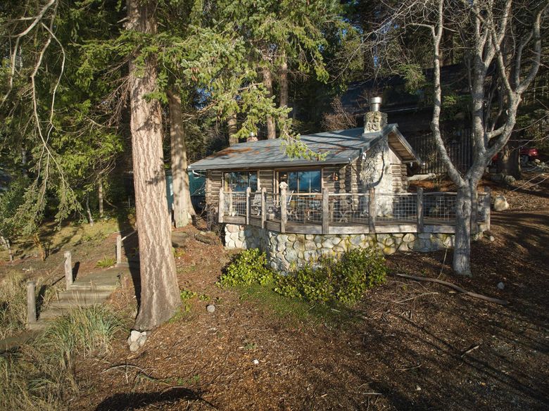 Pam Austin&#8217;s log cabin on Guemes Island, Skagit County, Dec. 12, 2023. For years, the antique cottage off the coast of Washington had served her well — but with grandchildren on the way, she needed a little extra space. (Moris Moreno / The New York Times)