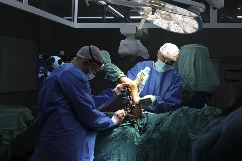 Surgeons operate on a Palestinian wounded in the Israeli bombardment of the Gaza Strip in a hospital in Rafah on Saturday, Dec. 30, 2023. (Hatem Ali / The Associated Press)