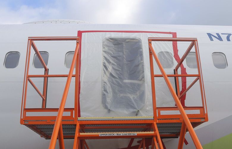 This photo released by the National Transportation Safety Board shows a gaping hole where the paneled-over door had been at the fuselage plug area of Alaska Airlines Flight 1282 on Sunday, Jan. 7, 2024, in Portland, Ore. A panel used to plug an area reserved for an exit door on the Boeing 737 Max 9 jetliner blew out Jan. 5, shortly after the flight took off from Portland, forcing the plane to return to Portland International Airport. (National Transportation Safety Board via AP) TKSJ802 TKSJ802