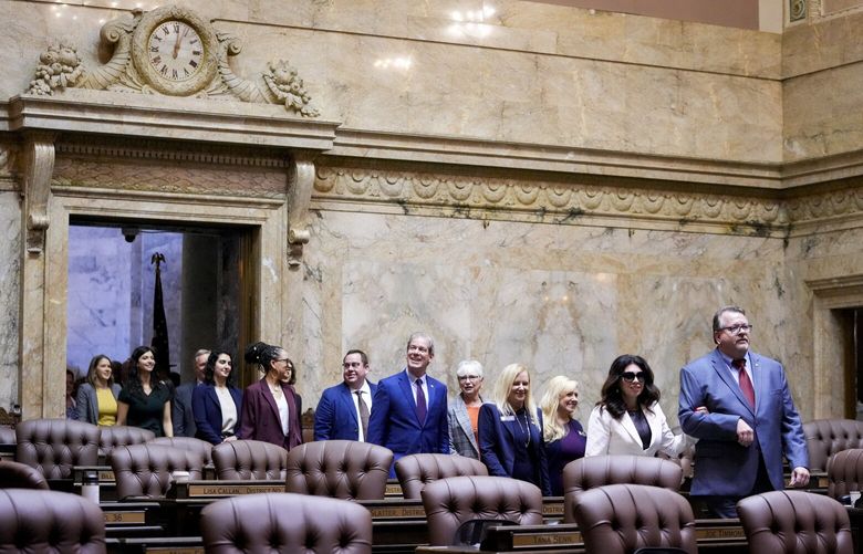 Members of the House, including Rep. Michelle Caldier, R-Gig Harbor, and Rep. Eric Robertson, R-Sumner, at front, walk into the House chambers during opening ceremonies on the first day of the legislative session at the Washington state Capitol, Monday, Jan. 8, 2024, in Olympia, Wash. (AP Photo/Lindsey Wasson) WALW112 WALW112