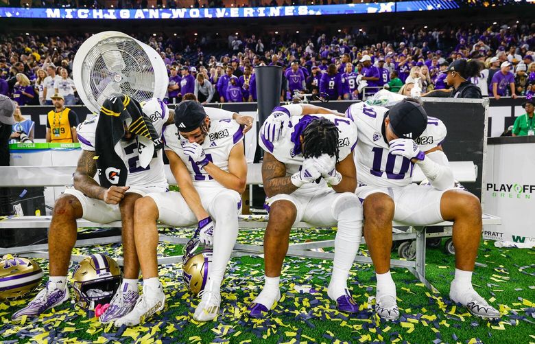 Washington huddles on the bench following their loss to Michigan in the National Championship game.  The Michigan Wolverines played the Washington Huskies in the CFP National Championship Monday, January 8, 2024 at NRG Stadium, in Houston, TX. 225905