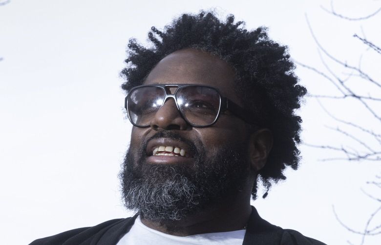 Chukundi Salisbury, executive director of Black Legacy Homeowners, stands in front of his Seattle home Friday, December 29, 2023.   Black Legacy Homeowners is an organization that empowers Black homeowners through educational resources and helps them fight displacement. BLH helps Black homeowners stay in their homes. Most people know of BLH through their iconic yard signs. 225842