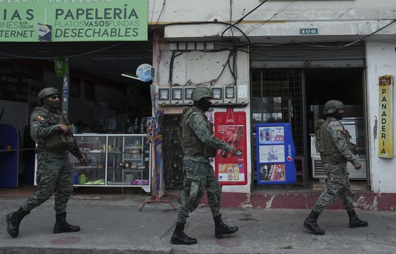 Soldiers patrol the perimeter of Inca prison during a state of emergency in Quito, Ecuador, Tuesday, Jan. 9, 2024, in the wake of the apparent escape of a powerful gang leader from prison. President Daniel Noboa decreed Monday a national state of emergency, a measure that lets authorities suspend people’s rights and mobilize the military in places like the prisons. The government also imposed a curfew from 11 p.m. to 5 a.m. (AP Photo/Dolores Ochoa) DOR101 DOR101