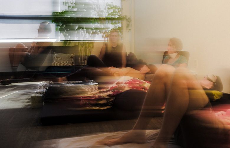 A long exposure of participants take turns practicing breathing exercises and tending to a peers, in San Francisco, on Oct. 7, 2023. As psychedelics move from the underground to mainstream medicine, clinicians aspiring to work in the field are inducing altered states with deep breathing. (Damien Maloney/The New York Times) XNYT0275