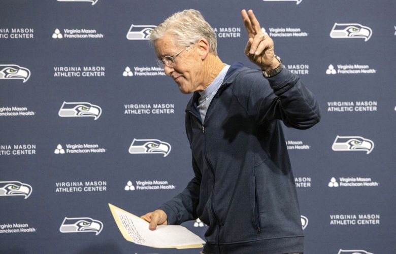 Former Seahawks Head Coach Pete Carroll waves as he leaves the podium at a press conference after talking about his departure as the Seahawks head coach at the VMAC in Renton Wednesday, January 10, 2024. 225940 225940