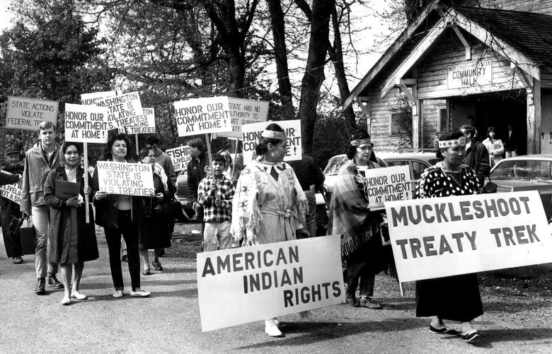 5/13/1966
13-Mile Walk on Friday the 13th
Members of the Muckleshoot Indian Tribe walked past the Muckleshoot Community Hall east of Auburn today at the beginning of their Auburn Federal Way trek to cell attention to their dispute with the sate over fishing rights. Fewer than 50 sign carrying marchers participated in the 13-mile walk.