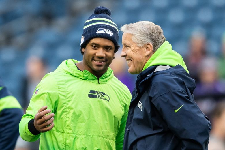 Seattle Seahawks quarterback Russell Wilson (3) and head coach Pete Carroll chat before the Monday Night Football game between the Seattle Seahawks and the Minnesota Vikings at CenturyLink Field in Seattle in December of 2019. (Andy Bao / The Seattle Times, 2019)