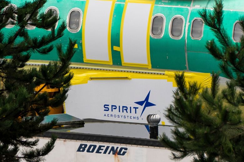 Spirit AeroSystems signage is seen near a Boeing 737 MAX 8 fuselage outside the Boeing assembly plant in Renton. Shares of Boeing have fallen almost 13% since the Flight 1282 accident. (David Ryder / Bloomberg)