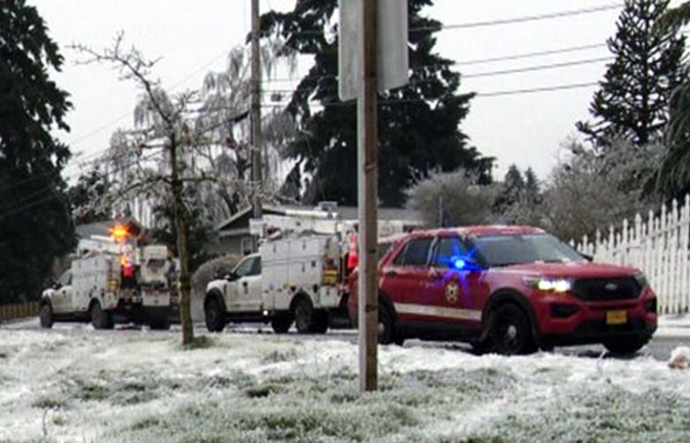 In this image made from a video provided by KGW, authorities work the scene Wednesday, Jan. 17, 2024, in Portland, Ore, after a power line fell on a vehicle, killing three people and injuring a baby during an ice storm that turned roads and mountain highways treacherous in the Pacific Northwest. (KGW via AP) PD303 PD303