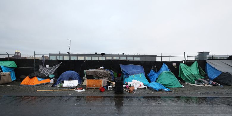 Tents line Third Avenue South in Sodo on a chilly, rainy day in Seattle. The U.S. Supreme Court agreed to hear a case that could eliminate protections for people living outside and give West Coast cities more power in clearing encampments. (Karen Ducey / The Seattle Times)