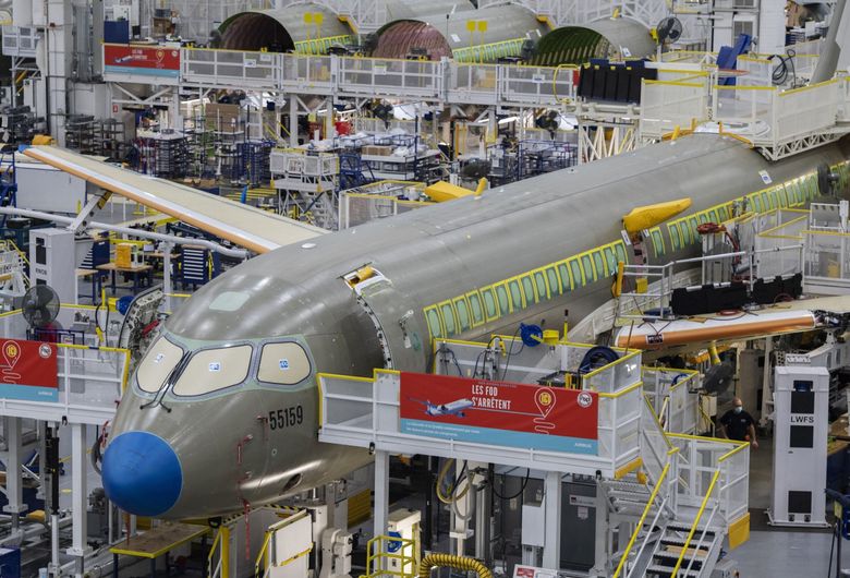 An Airbus A220 comes together at the Airbus Canada assembly plant in Mirabel, Quebec, in 2021. Airbus bought this small-jet series from Bombardier when the Canadian jetmaker could no longer finance the program. By 2026, Airbus plans to increase A220 production to 14 jets per month. (Graham Hughes / Bloomberg, 2021)