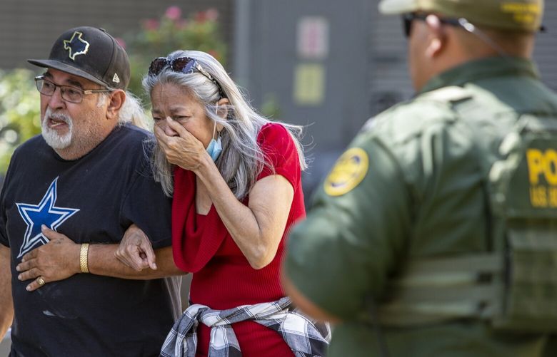 FILE – A woman cries as she leaves the Uvalde Civic Center, Tuesday May 24, 2022, in Uvalde, Texas, after a mass shooting. AA federal report into the halting and haphazard law enforcement response to a school shooting in Uvalde, Texas, was scheduled to be released Thursday, Jan. 18, 2024, reviving scrutiny of the hundreds of officers who responded to the 2022 massacre but waited more than an hour to confront and kill the gunman. (William Luther/The San Antonio Express-News via AP, File) TXSAE101 TXSAE101