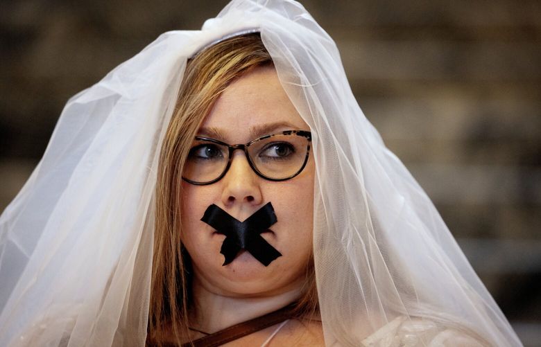 Courtney McGrath, part of Unchained At Last, a group supporting bill HB 1455 to end child marriage in Washington, helps bring awareness to the issue inside the Washington State Capitol building, Thursday, Jan. 18, 2024 in Olympia. The House passed the bill on the first day of session and it is now heading to the Senate.