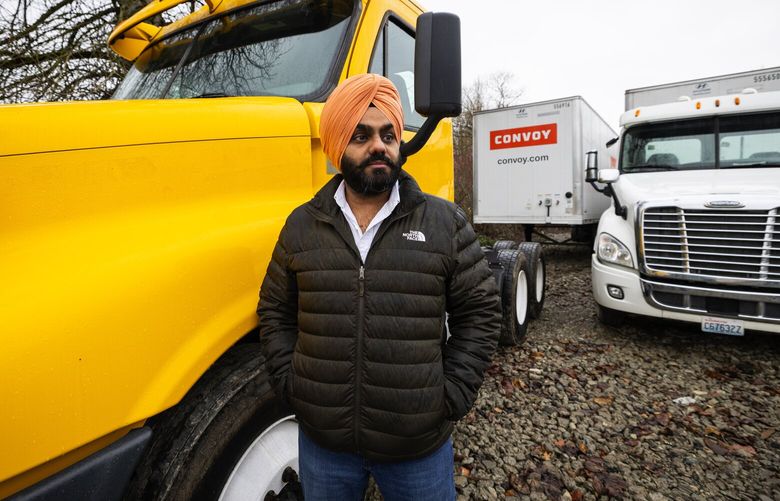 Angadjot (AJ) Singh Sandhu, Wednesday, Jan. 10, 2024 in Auburn with the trucks he owns (the cabs), before returning Convoy trailers (what is pulled). The truck at left was just purchased. Sandhu is owed $40,000 and also has other losses after his small trucking business used Convoy. 225917