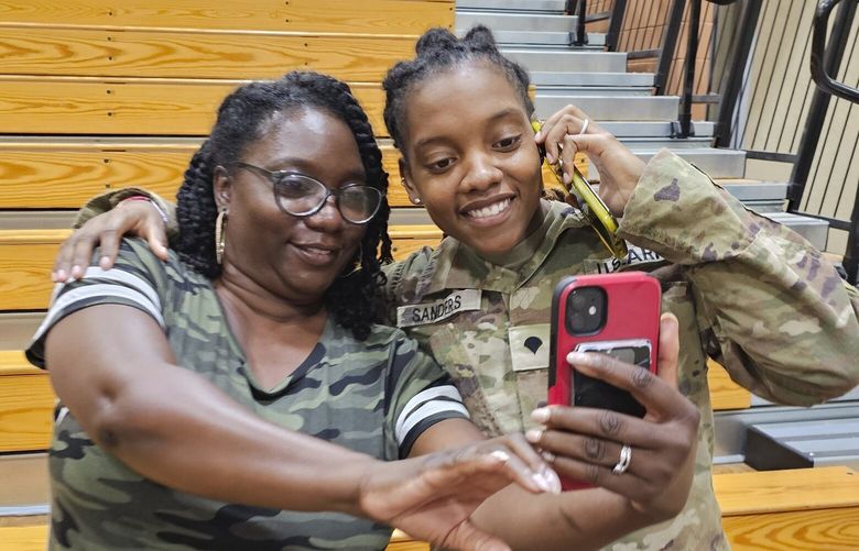 This undated image provided by Shawn Sanders shows Army Spc. Kennedy Sanders, right, posing for a selfie with her mother, Oneida Oliver-Sanders, at a ceremony in Columbus, Ga., on Aug. 9, 2023. The 24-year-old Army reservist’s parents confirmed she was among three U.S. service members killed Sunday, Jan. 28, 2024, by a drone strike at their base in Jordan near the border with Syria. Sanders of Waycross, Georgia, joined the Army Reserve five years ago, her parents said, and was taking college courses to become an X-ray technician. (Shawn Sanders via AP) NYPS225 NYPS225