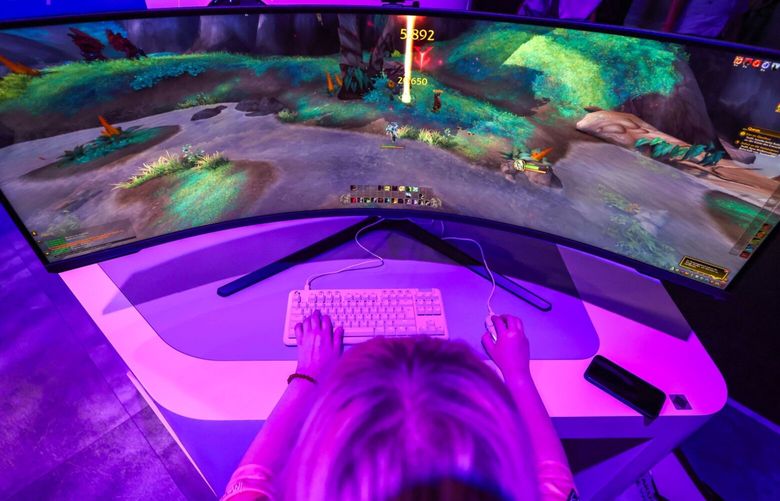 A gamer uses a Samsung Odyssey Neo curved monitor while sampling a game at the Gamescon video games trade fair in Cologne, Germany, on Wednesday, Aug. 23, 2023. Gamescon runs until Sunday, Aug. 27. 776022402