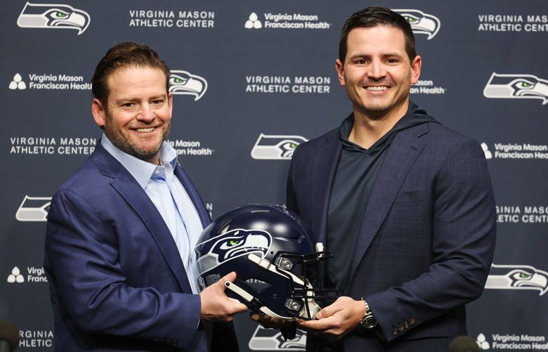 Seahawks general manager John Schneider introduces new head coach Mike Macdonald at a news conference in Renton on Thursday, Feb. 1, 2024. (Kevin Clark / The Seattle Times)