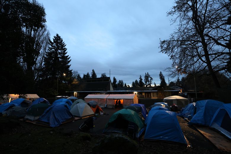 Burien’s only sanctioned encampment, Sunnydale Village, winds down in the evening Dec. 14. At its peak, 65 people lived there. (Karen Ducey / The Seattle Times)