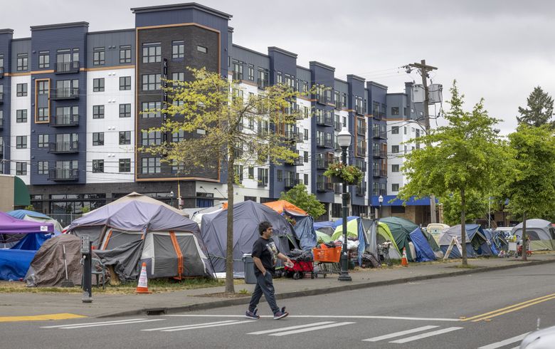 A large encampment sits in downtown Burien on what was an unofficial dog park. It slowly grew from April to May of 2023 after campers were moved from a spot near City Hall. (Ellen M. Banner / The Seattle Times, 2023)
