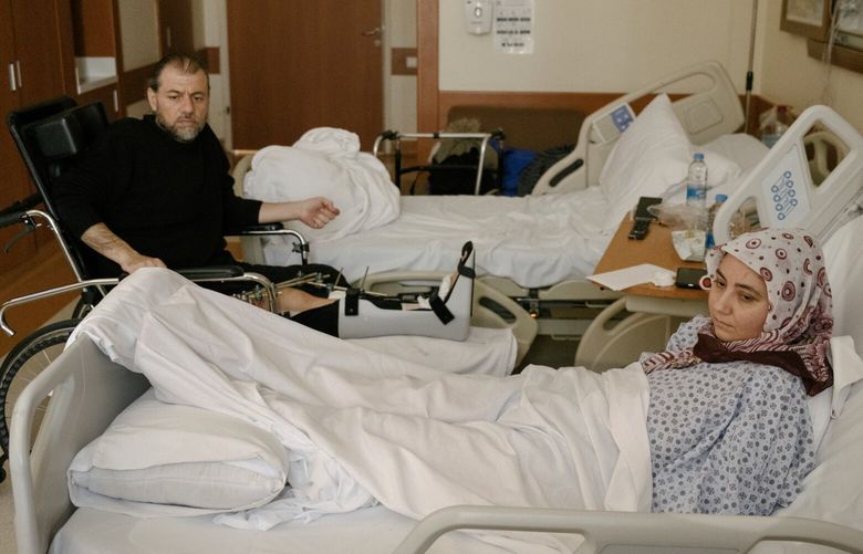 Ibrahim Karapirli and his wife Pinar, who had leg and arm surgeries for injuries suffered in the earthquake that pancaked the six-story apartment building where they lived, at the hospital in Gaziantep, Turkey, April 4, 2023. The couple lost their 9 and 10-year-old sons to the 7.8-magnitude earthquake before dawn on Feb. 6, 2023. (Emin Ozmen/The New York Times) XNYT0497 XNYT0497
