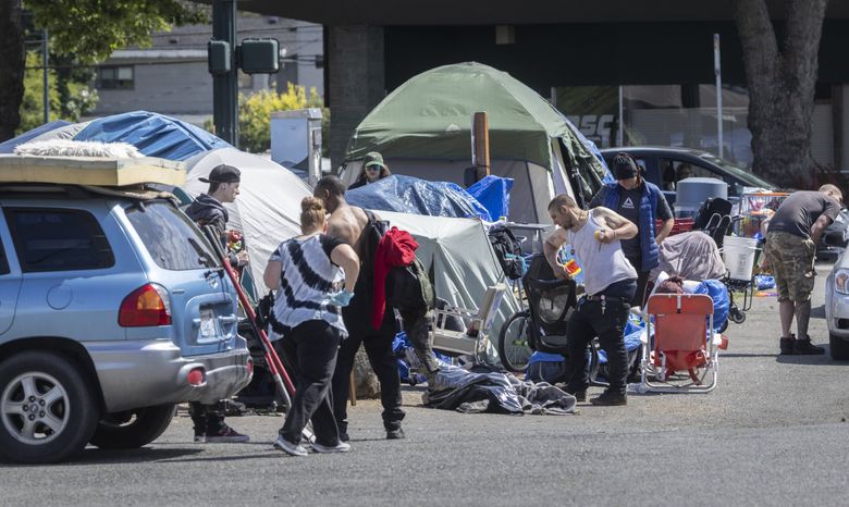 Residents of this controversial homeless encampment in downtown Burien start packing up their possessions on May 31, with a deadline of midnight. (Ellen M. Banner / The Seattle Times)