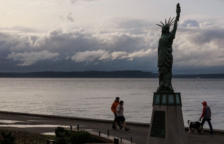 Pedestrians walk by Seattle’s Statue of Liberty at Alki Beach in West Seattle Tuesday, Sept. 26, 2023. 224953