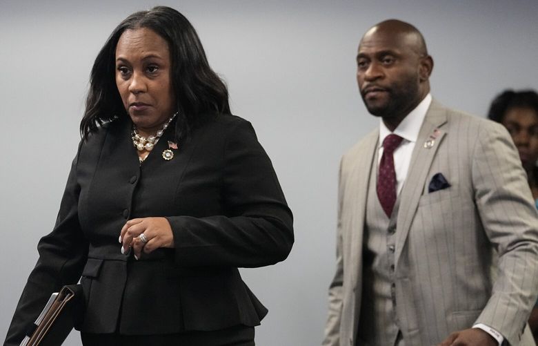 FILE – Fulton County District Attorney Fani Willis, followed by special prosecutor Nathan Wade, right, arrives for a news conference at the Fulton County Government Center, Monday, Aug. 14, 2023, in Atlanta. Willis acknowledged in a court filing on Friday, Feb. 2, 2024, having a “personal relationship” with Wade, a special prosecutor she hired for the Georgia election interference case against former President Donald Trump, but argued there are no grounds to dismiss the case or to remove her from the prosecution. (AP Photo/John Bazemore, File) NYDD214 NYDD214
