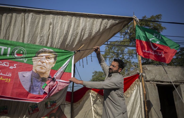 Supporters of Pakistan Tehreek-e-Insaf, the party of Imran Khan, put up a banner in Lahore on Election Day, Thursday, Feb. 8, 2024, despite being banned from campaigning. The party won the most seats in parliamentary elections this week, delivering a strong rebuke to the country’s powerful generals and throwing the political system into chaos. (Saiyna Bashir/The New York Times) XNYT0262 XNYT0262