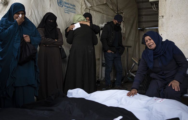 Palestinians mourn relatives killed in the Israeli bombardment in Rafah, Gaza Strip, Saturday, Feb.10, 2024. (AP Photo/Fatima Shbair) DV103 DV103