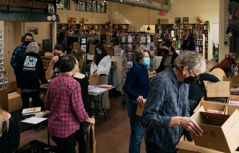 Volunteers at Firestorm Books in Asheville, N.C., on Jan. 28. MUST CREDIT: Jesse Barber for The Washington Post