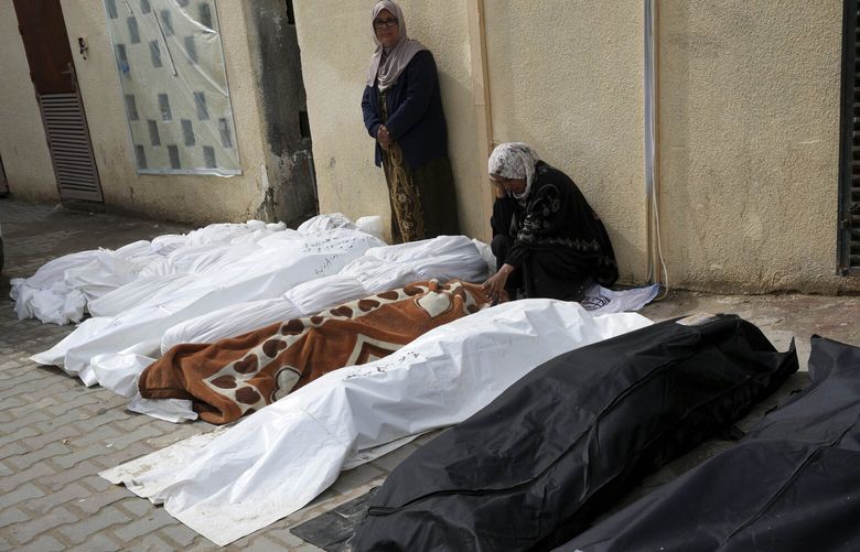 Palestinians mourn over their relatives killed in the Israeli bombardments of the Gaza Strip at Al Aqsa Hospital in Deir al Balah, Gaza Strip, on Sunday, Feb. 18, 2024. (AP Photo/Adel Hana) XOB119 XOB119