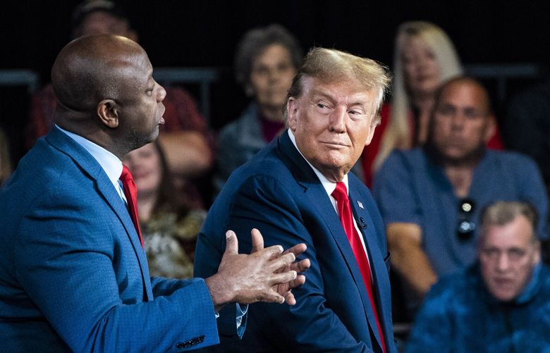 Former president Donald Trump speaks with Sen. Tim Scott (R-S.C.) and moderator Laura Ingraham during a Fox News town hall in Greenville, S.C., on Tuesday. MUST CREDIT: Jabin Botsford/The Washington Post