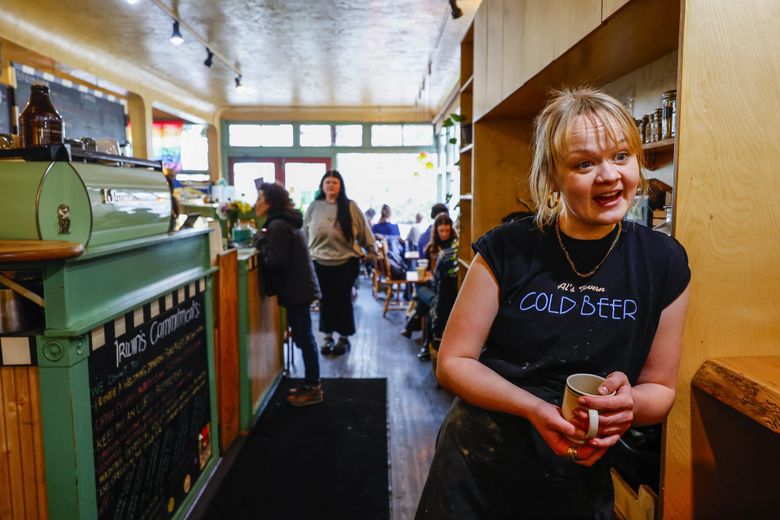 Amber Richards, who works at Irwin’s Bakery and Cafe in Wallingford, knows most of her customers by name, and a great many events in their lives. (Dean Rutz / The Seattle Times)