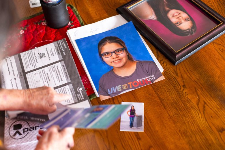 Bonnie Groo looks through portraits of her great-granddaughter, Kit Mora, in her home in Yakima, Wash. Kit, who goes by they/them pronouns, went missing in 2021 at the age of 16 while under the care of their biological mother. (Jake Parrish / InvestigateWest, 2023)