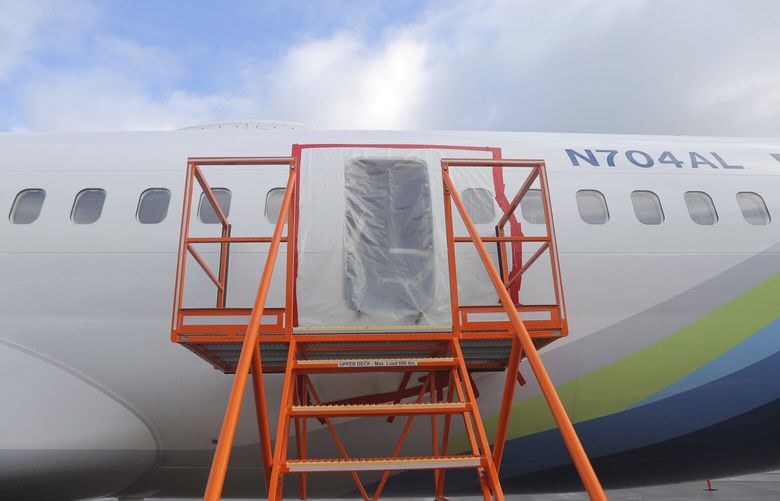 This photo released by the National Transportation Safety Board shows a gaping hole where the paneled-over door had been at the fuselage plug area of Alaska Airlines Flight 1282 on Sunday, Jan. 7, 2024, in Portland, Ore. A panel used to plug an area reserved for an exit door on the Boeing 737 Max 9 jetliner blew out Jan. 5, shortly after the flight took off from Portland, forcing the plane to return to Portland International Airport. (National Transportation Safety Board via AP) TKSJ802