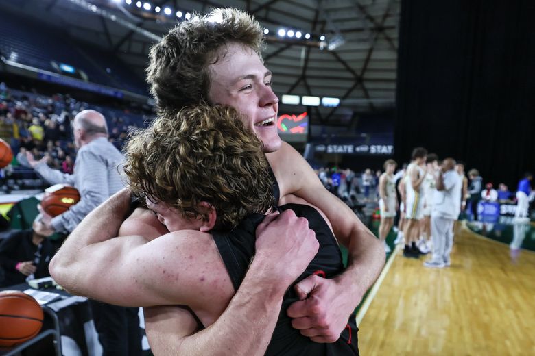 Mount Si’s Trevor Hennig, left, and Mount Si’s Blake Forrest celebrating winning the title Saturday evening during the 4A State Basketball Championships finals at the Tacoma Dome in Tacoma. Mount Si won 72-58. (Kevin Clark / The Seattle Times)