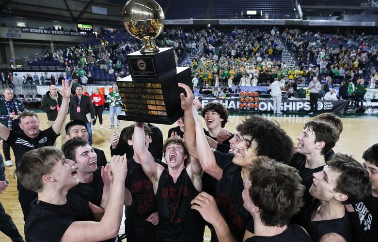 Mount Si’s Blake Forrest hoist the championship trophy Saturday evening during the 4A State Basketball Championships finals at the Tacoma Dome in Tacoma, Washington, on March 2, 2024. Mount Si won 72-58. 226259