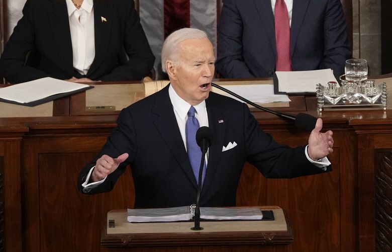 President Joe Biden speaks during the State of the Union address on Capitol Hill, Thursday, March 7, 2024, in Washington, as Vice President Kamala Harris and House Speaker Mike Johnson of La., watch. (AP Photo/Mark Schiefelbein) DCMS320 DCMS320