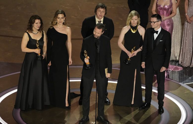 Raney Aronson-Rath, from left, Vasilisa Stepanenko, Mstyslav Chernov, Evgeniy Maloletka, Michelle Mizner, and Derl McCrudden accept the award for best documentary feature film for “20 Days in Mariupol” during the Oscars on Sunday, March 10, 2024, at the Dolby Theatre in Los Angeles. (AP Photo/Chris Pizzello)APTO CARA1089 CARA1089