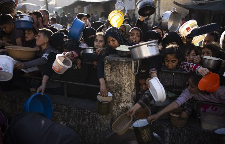 Palestinians line up for a free meal in Rafah, Gaza Strip, on Tuesday, March 12, 2024. (AP Photo/Fatima Shbair) XOB113 XOB113