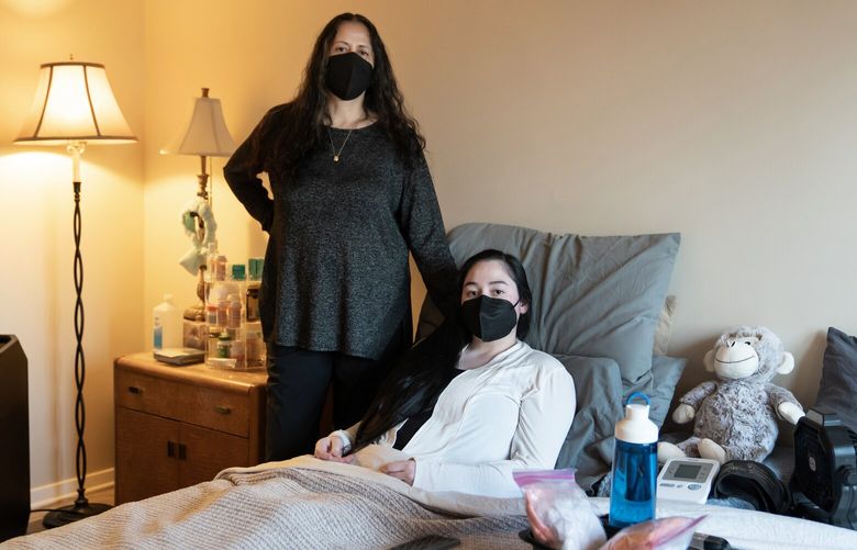 Paris Dolfman, right, with her mother, Alicia Martinez, at their home in Roswell, Ga on March 12, 2024. Dolfman had a mild Covid infection in 2022 that turned into an excruciating case of long Covid that has upended her life. (Nicole Craine/The New York Times)